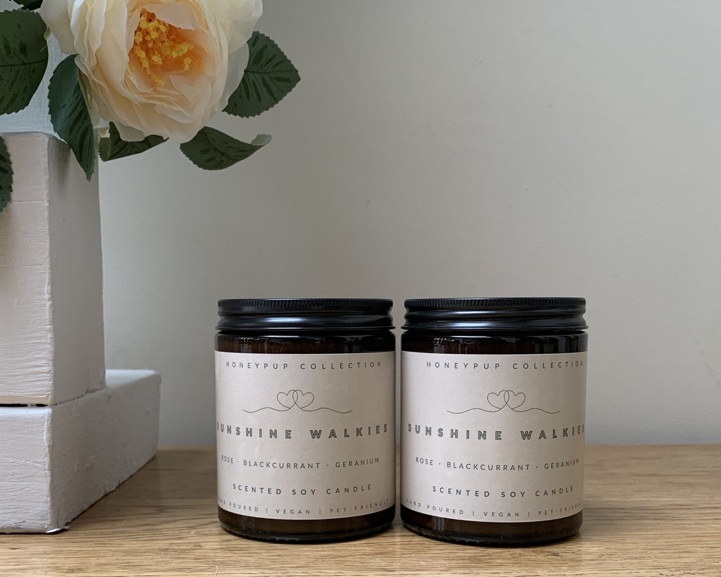 Sunshine Walkies candles on a wooden surface